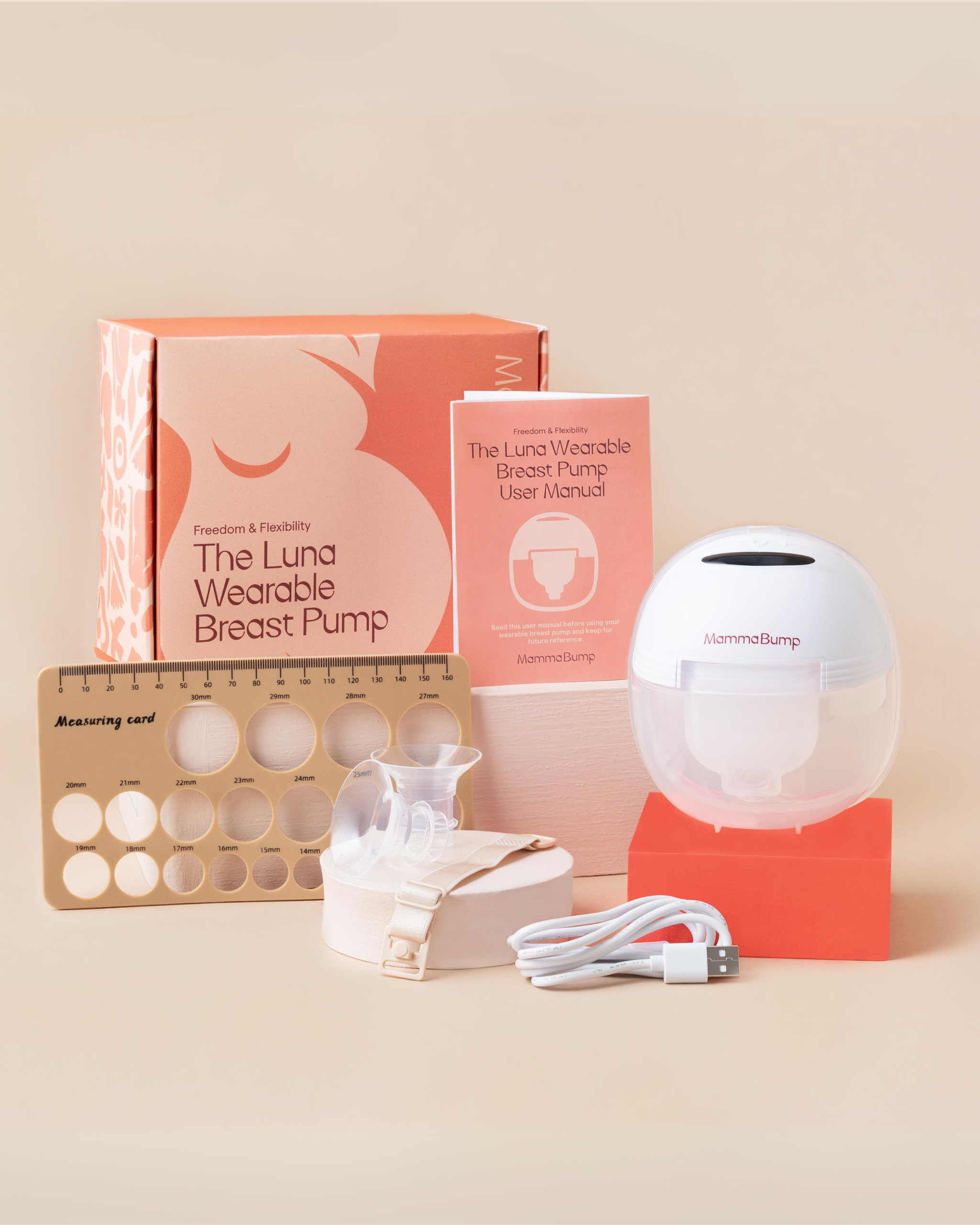The Luna wearable breast pump with its packaging, nipple measurer, additional flange inserts, bra extender, charing cable and instruction manual.
