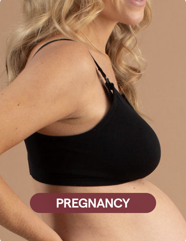 Woman wearing a black maternity bra with 'PREGNANCY' label on a beige background