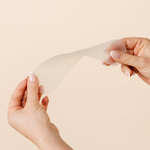 Close-up of hands demonstrating the flexibility of a MammaBump C-Section Silicone Scar Strip for gentle cesarean scar care