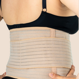 Close-up of a new mum wearing the tan MammaBump Postpartum Belly Band, showing full abdominal and lower back coverage for postpartum recovery