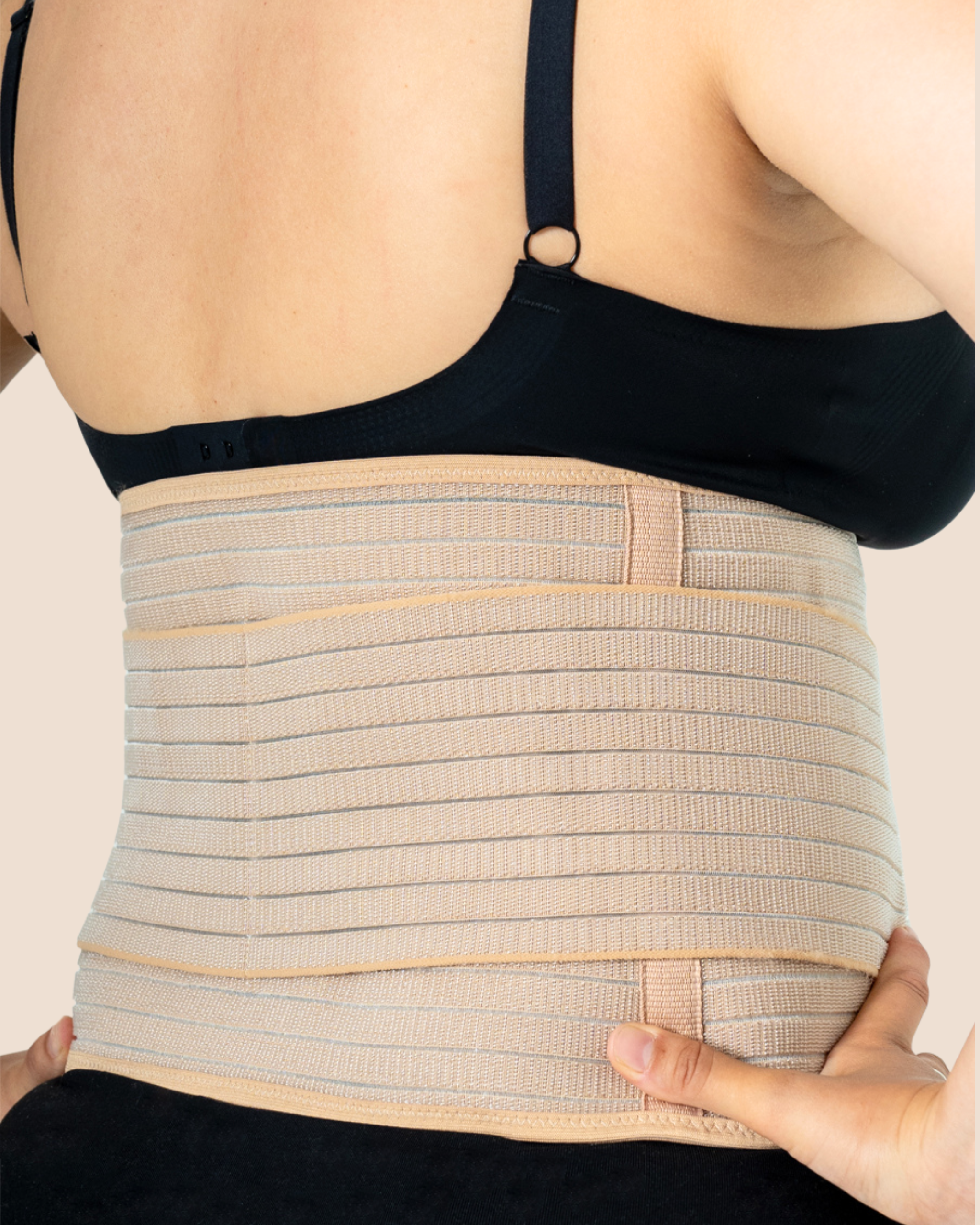 Close-up of a new mum wearing the tan MammaBump Postpartum Belly Band, showing full abdominal and lower back coverage for postpartum recovery