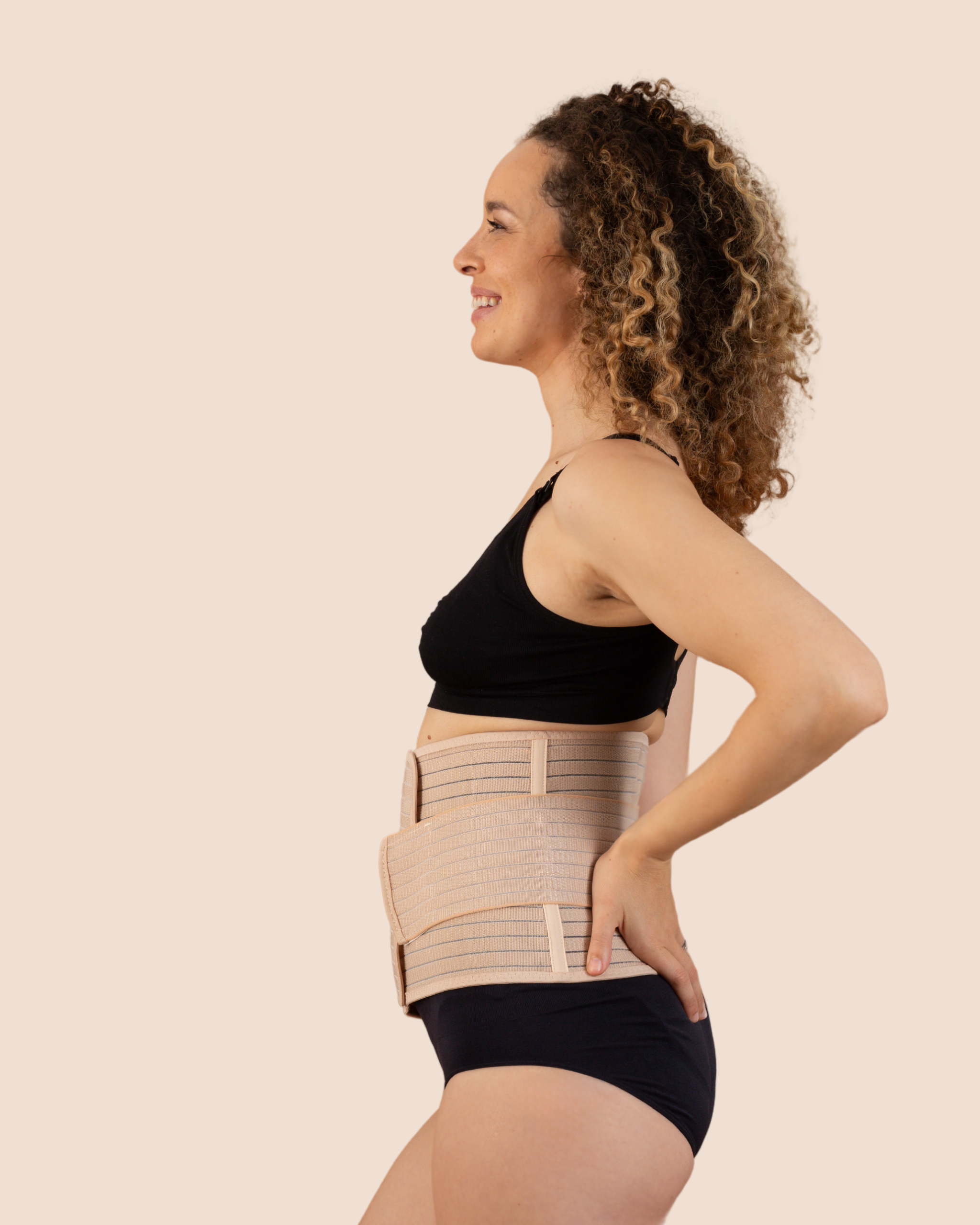 Side profile of a new mum wearing the tan MammaBump Postpartum Belly Band, showing gentle abdominal and lower back support during postpartum recovery