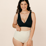 Smiling new mum wearing cream MammaBump Postpartum Soothing Briefs, high-waisted and seamless for comfortable postpartum recovery