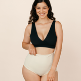 Smiling new mum wearing cream MammaBump Postpartum Soothing Briefs, high-waisted and seamless for comfortable postpartum recovery