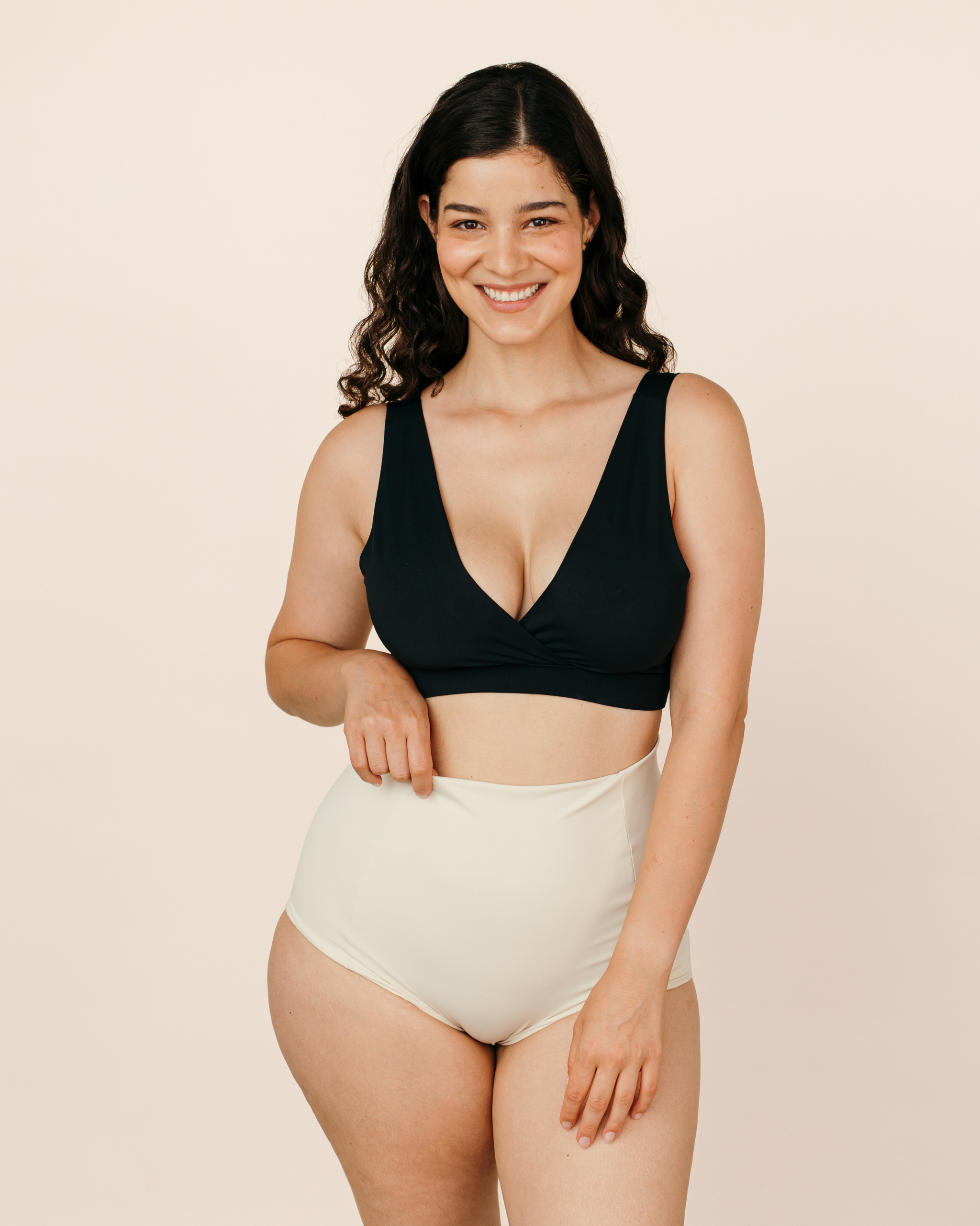 Smiling new mum wearing cream MammaBump Postpartum Soothing Briefs, high-waisted and seamless for comfortable postpartum recovery